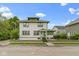 Charming two-story home with green accents, covered porch, and a well-maintained front yard at 236 W 33Rd St, Indianapolis, IN 46208