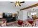 Spacious living room featuring a large television, hardwood floors, and open to the dining area at 236 W 33Rd St, Indianapolis, IN 46208