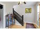 Staircase with dark-stained wood, light-colored walls, and adjacent cabinet at 236 W 33Rd St, Indianapolis, IN 46208