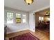 Bright sunroom with windows and hardwood floors that connect to the dining room at 236 W 33Rd St, Indianapolis, IN 46208