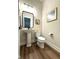 Modern powder room featuring a pedestal sink, stylish mirror, and sleek fixtures at 247 Poplar St, Westfield, IN 46074