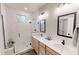 Modern bathroom with double vanity, herringbone tile shower, and stylish fixtures at 247 Poplar St, Westfield, IN 46074