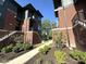 View of modern townhouses showing well-manicured landscaping, sidewalks, and classic brick and siding design at 247 Poplar St, Westfield, IN 46074