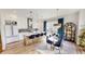 Open-concept kitchen featuring white cabinetry, a large island, and a dining space with contemporary lighting at 247 Poplar St, Westfield, IN 46074