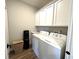 Functional laundry room with white cabinets and modern washer and dryer at 247 Poplar St, Westfield, IN 46074