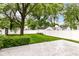Serene backyard featuring mature tree, green grass, shed, and a white fence at 2526 Dell Zell Dr, Indianapolis, IN 46220