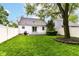 Well-maintained backyard with a white fence, patio, and lush green lawn at 2526 Dell Zell Dr, Indianapolis, IN 46220