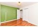 Bedroom with hardwood floors, closet and green accent wall at 2526 Dell Zell Dr, Indianapolis, IN 46220