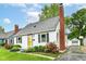 Charming single-story home with a brick chimney, black shutters and manicured landscaping at 2526 Dell Zell Dr, Indianapolis, IN 46220