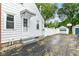 Side view of a home with a driveway and garage, surrounded by a white fence at 2526 Dell Zell Dr, Indianapolis, IN 46220