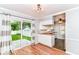 Eat-in kitchen with wood floors, white cabinets, butcher block countertops and stainless steel appliances at 2526 Dell Zell Dr, Indianapolis, IN 46220