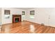Living room featuring hardwood floors, a brick fireplace, and large windows at 2526 Dell Zell Dr, Indianapolis, IN 46220