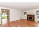 Bright living room with hardwood floors and a brick fireplace at 2526 Dell Zell Dr, Indianapolis, IN 46220