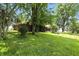 Lush green backyard with mature trees, offering a serene and private outdoor setting for relaxation at 25420 Jerkwater Rd, Sheridan, IN 46069