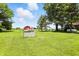 Lush backyard featuring a red barn, open lawn, and mature trees at 25420 Jerkwater Rd, Sheridan, IN 46069