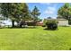 Wide shot of backyard with grass, trees, and outbuildings at 25420 Jerkwater Rd, Sheridan, IN 46069