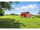Scenic view of a well-maintained red barn in a large grassy field at 25420 Jerkwater Rd, Sheridan, IN 46069
