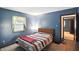 Inviting bedroom featuring blue walls, carpeted floor, window with valance, and a comfortable bed at 25420 Jerkwater Rd, Sheridan, IN 46069