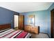Bedroom with blue walls, a red striped bedspread, and a matching dresser with mirror at 25420 Jerkwater Rd, Sheridan, IN 46069