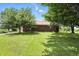 Charming single story home with a brick exterior and surrounded by mature trees and a green lawn at 25420 Jerkwater Rd, Sheridan, IN 46069