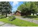 Charming brick home featuring a well-maintained lawn, mature trees, and a driveway leading to a detached garage at 25420 Jerkwater Rd, Sheridan, IN 46069