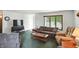 Cozy living room featuring carpeted flooring, a large window and comfortable seating arrangements at 25420 Jerkwater Rd, Sheridan, IN 46069