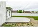 View of the backyard with a new concrete patio and a privacy fence at 321 Virginia St, Fortville, IN 46040