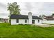 View of this home's backyard with new patio, black roof, and white siding at 321 Virginia St, Fortville, IN 46040