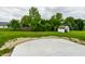 Spacious backyard features a new concrete patio, a fire pit, a shed, and lots of greenery at 321 Virginia St, Fortville, IN 46040