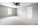 Bright bedroom showcasing plush carpeting, a ceiling fan, a window, and a closet door at 321 Virginia St, Fortville, IN 46040