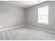 Bright bedroom with neutral walls, plush carpeting, and a large window overlooking the yard at 321 Virginia St, Fortville, IN 46040