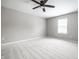 A clean and bright bedroom with neutral carpet, ceiling fan, and a window with blinds at 321 Virginia St, Fortville, IN 46040