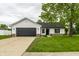 Charming single-story home with a dark garage door and well-maintained front yard at 321 Virginia St, Fortville, IN 46040
