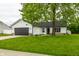 Charming one-story home with a well-kept lawn and a large tree in the front yard at 321 Virginia St, Fortville, IN 46040
