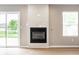 Living room fireplace with white tiling detail between a sliding glass door and a window at 321 Virginia St, Fortville, IN 46040