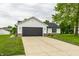 A long driveway leads to this home's two-car garage at 321 Virginia St, Fortville, IN 46040