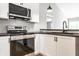 The kitchen boasts stainless steel appliances and modern fixtures at 321 Virginia St, Fortville, IN 46040