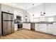 Bright, modern kitchen with stainless steel appliances, white cabinets, and black countertops at 321 Virginia St, Fortville, IN 46040