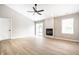 Light and airy living room with wood-look floors, a fireplace and natural light at 321 Virginia St, Fortville, IN 46040