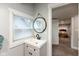 Bathroom featuring stylish sink and fixtures, natural light, and a view to bedroom at 326 Parkway Ave, Indianapolis, IN 46225