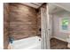 Bathroom showcasing shower with wood style tile, and white tub at 326 Parkway Ave, Indianapolis, IN 46225