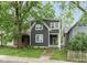 Charming two-story home featuring a modern gray facade, white trim, and a vibrant green front door at 326 Parkway Ave, Indianapolis, IN 46225
