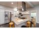 Well-lit open kitchen with granite countertops, stainless steel appliances, and a large kitchen island with seating at 326 Parkway Ave, Indianapolis, IN 46225