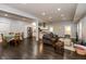 Expansive open-concept living space flows seamlessly into the kitchen, featuring dark hardwood floors and modern decor at 326 Parkway Ave, Indianapolis, IN 46225