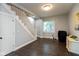 Inviting living room features hardwood floors, neutral paint, and staircase access at 326 Parkway Ave, Indianapolis, IN 46225