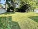 Fully sodded back yard is completely level with a border of mature trees and a privacy fence at 3321 Sycamore Dr, Columbus, IN 47203