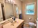 Well-lit bathroom featuring a vanity with ample counter space and a large mirror at 3321 Sycamore Dr, Columbus, IN 47203