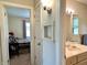 A view into the bathroom showing the vanity and connecting hall to the bedroom at 3321 Sycamore Dr, Columbus, IN 47203