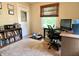Functional bedroom with a window, a dark wooden desk and comfortable office chair at 3321 Sycamore Dr, Columbus, IN 47203