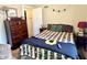 Comfortable bedroom with a decorative quilt and ample storage with a view to the hallway at 3321 Sycamore Dr, Columbus, IN 47203